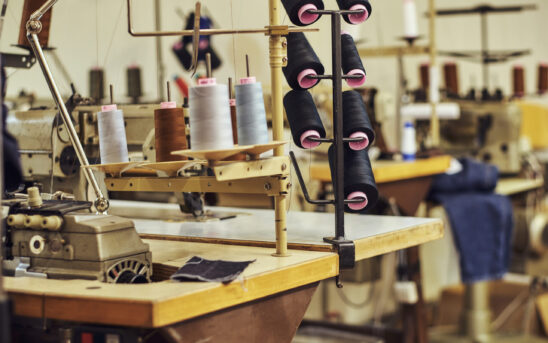 Close-up image of a lot of coils with a threads at the sewing workshop.